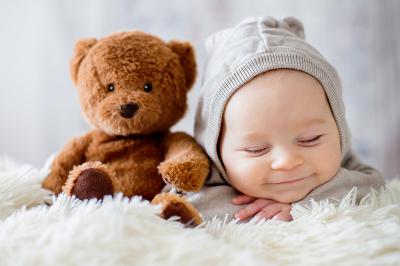 Newborn baby with a teddy bear
