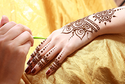 Henna being applied to hand