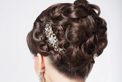 Woman with up hairdo and jewelled clip