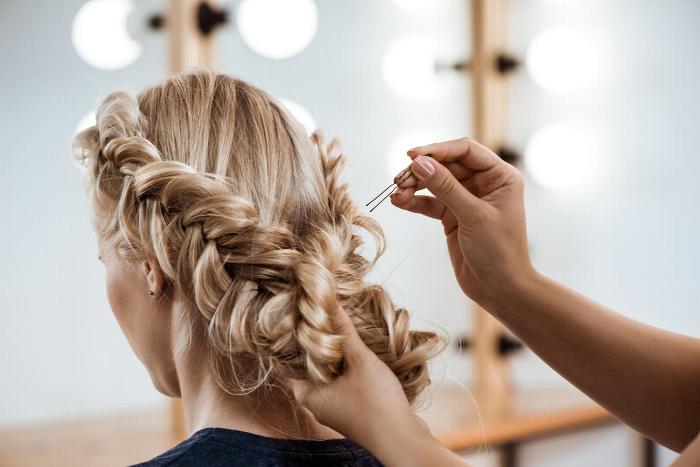 Hairdresser pinning up girls hair