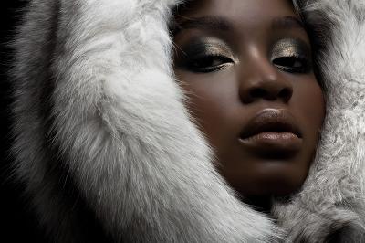 Model wearing a fur hood with silver eyeshadow